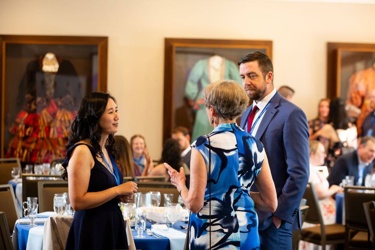 Business professionals networking at formal luncheon event
