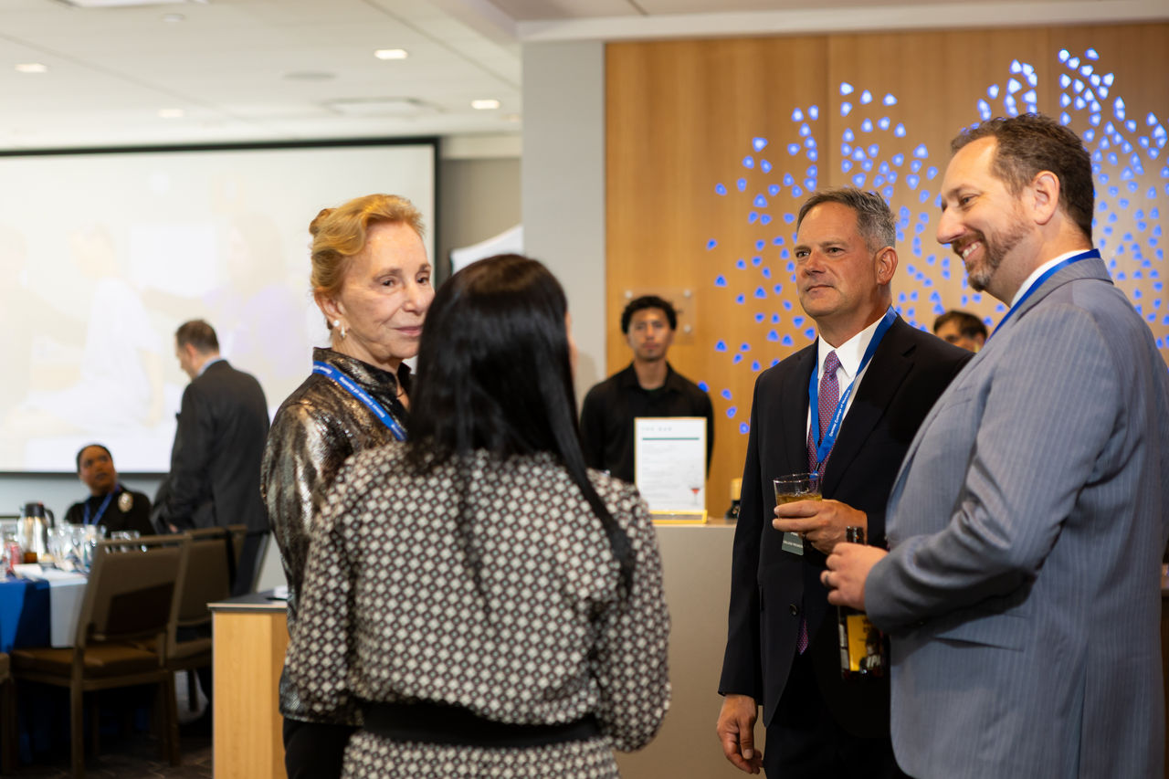 Business professionals networking at conference reception