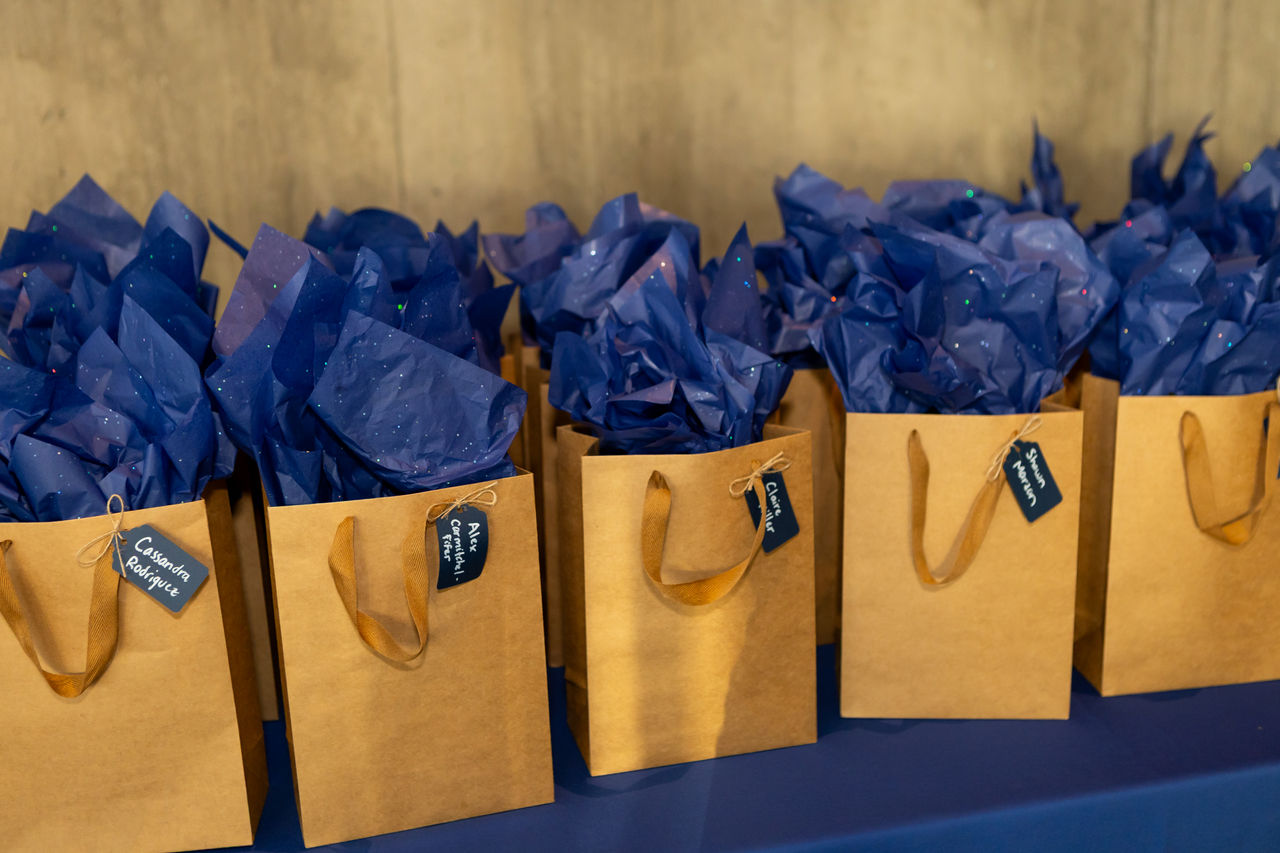 Gift bags with blue tissue paper on table